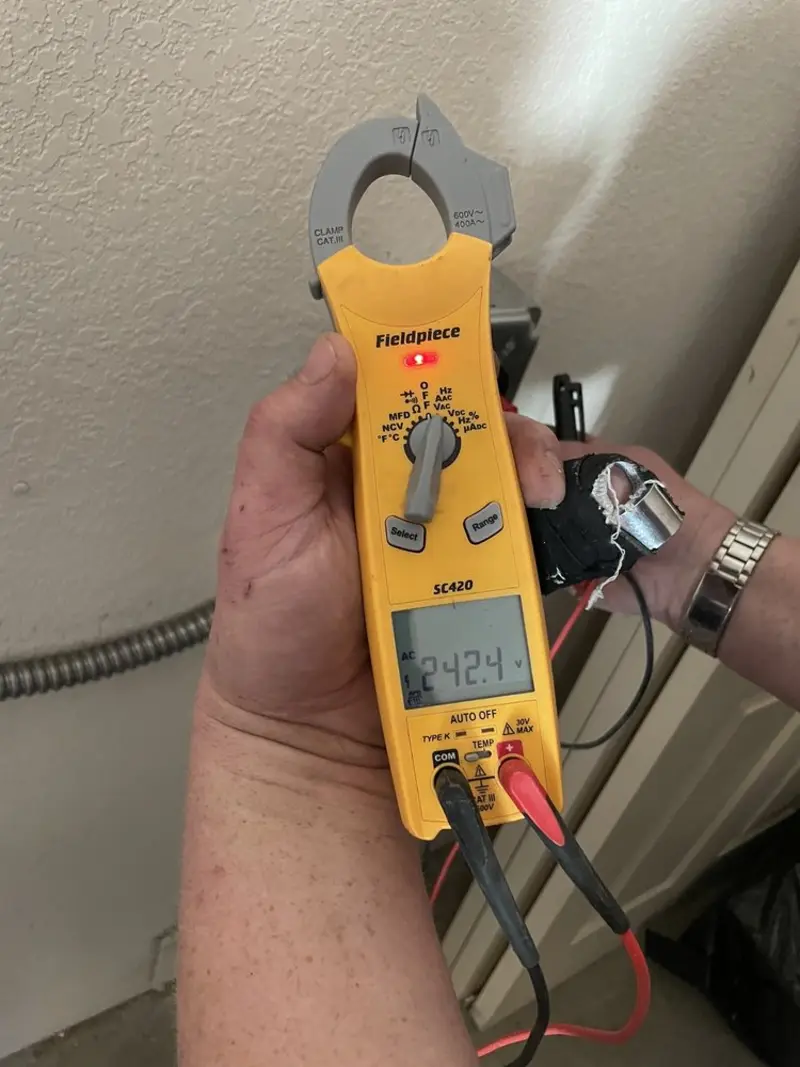 Voltage testing with clamp meter during Recessed Lighting Installation in Larchmont